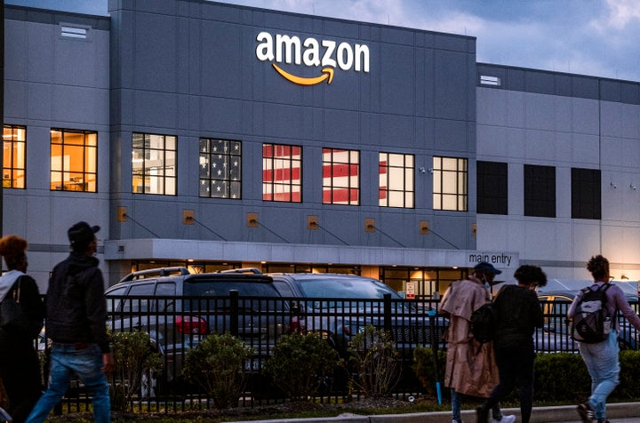 People arrive for work at the Amazon distribution center in Staten Island, New York, on Oct. 25, 2021.