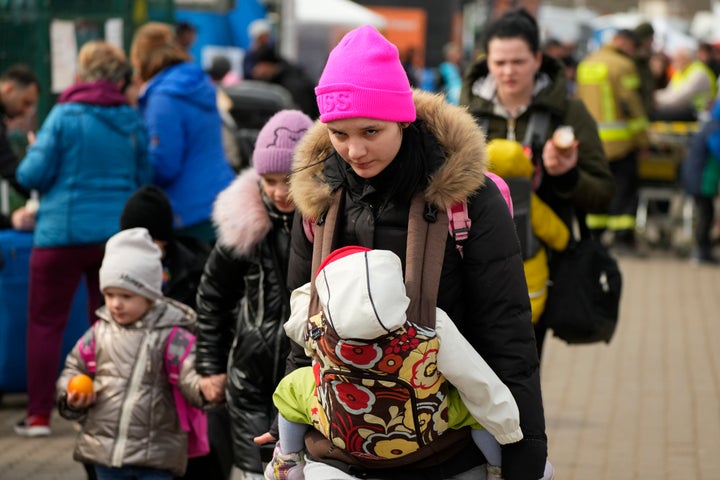 Ukrainian refugees depart from the border crossing in Medyka, southeastern Poland, on March 30, 2022.