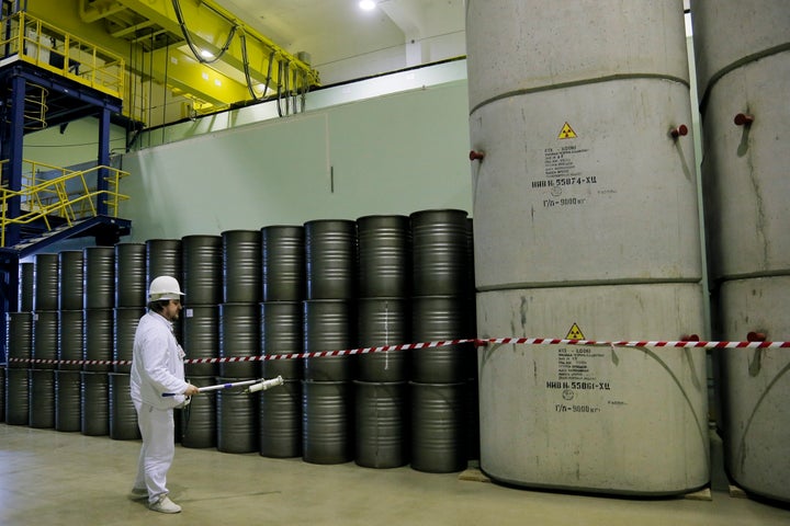 A worker checks the radiation level on barrels of nuclear waste taken from a unit destroyed at the Chernobyl nuclear power plant in 2016.
