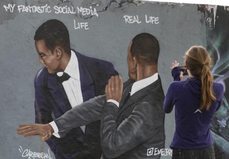 Graffiti art in Berlin by Dominican artist Jesus Cruz Artiles, also known as Eme Freethinker, depicting the night actor Will Smith slapped Chris Rock onstage at the 94th Academy Awards ceremony held at the Dolby Theatre in Los Angeles.