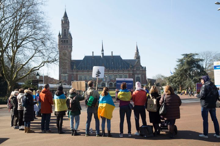 Ukrainian nationals stand outside the International Criminal Court of Justice, or Peace Palace, on the first day of hearings on March 7 in The Hague.