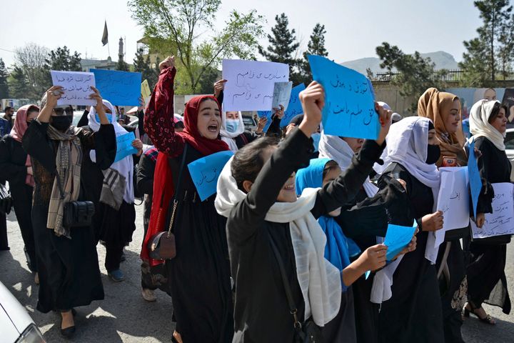 Afghan women and girls take part in a protest in front of the Ministry of Education in Kabul on March 26, demanding that high schools be reopened for girls.