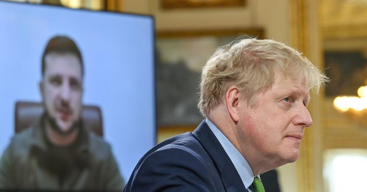 Boris Johnson listens as Ukrainian president Volodymyr Zelensky addresses by video link world leaders.