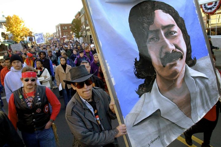 Marchers carry a painting of jailed Leonard Peltier during a march for the National Day of Mourning in Plymouth, Massachusetts, on Nov. 22, 2001.