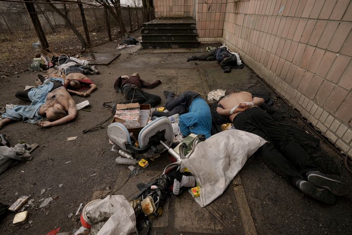 Lifeless bodies of men, some with their hands tied behind their backs, lie on the ground in Bucha, Ukraine, on April 3. Associated Press journalists in Bucha, a small city northwest of Kyiv, saw the bodies of at least nine people in civilian clothes who appeared to have been killed at close range. At least two had their hands tied behind their backs.