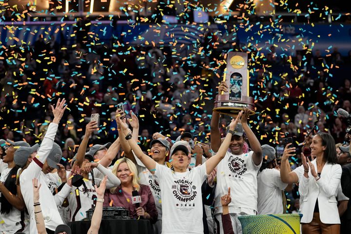 South Carolina head coach Dawn Staley celebrates with her team after a college basketball game in the final round of the Women's Final Four NCAA tournament against UConn Sunday, April 3, 2022, in Minneapolis. South Carolina won 64-49 to win the championship. (AP Photo/Eric Gay)