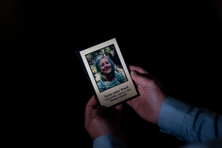 Harry Bruell holds a framed photo of his daughter, Taya, while sitting for a photo in his office in Santa Barbara, Calif., on March 9, 2022.