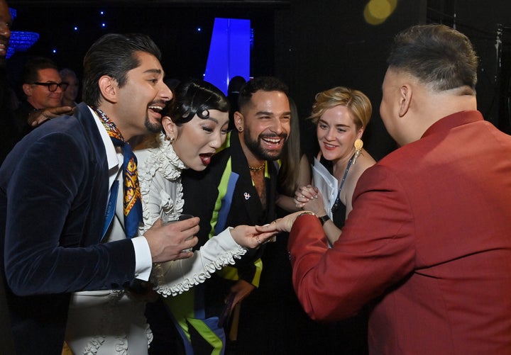 Santos (right) proudly shows off his engagement ring to actors Mark Indelicato, Poppy Liu and Johnny Sibilly.