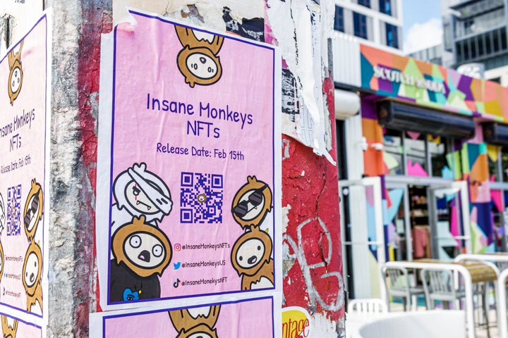 A poster advertising Insane Monkeys NFTs with QR code in Miami, Florida.