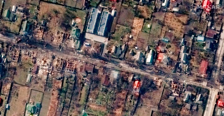 Overview of destroyed houses and vehicles in a street in Bucha, Ukraine on March 31, 2022. 