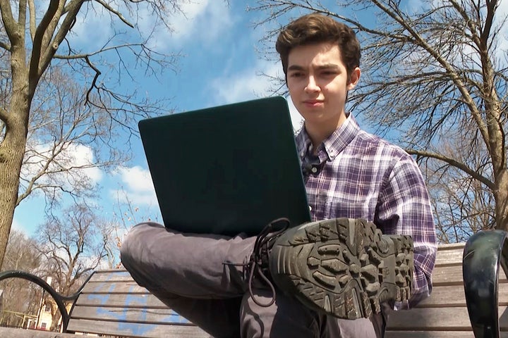 Harvard freshman Marco Burstein, 18, of Los Angeles, works on his computer near the campus of Harvard University in Cambridge, Mass., on March 16, 2022.