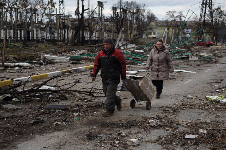 Local residents walks through the destroyed residential area on April 4, 2022 in Bucha, Ukraine.