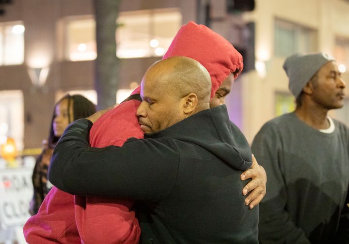 People hug each other near the scene of a mass shooting on April 3, 2022 in Sacramento, California.