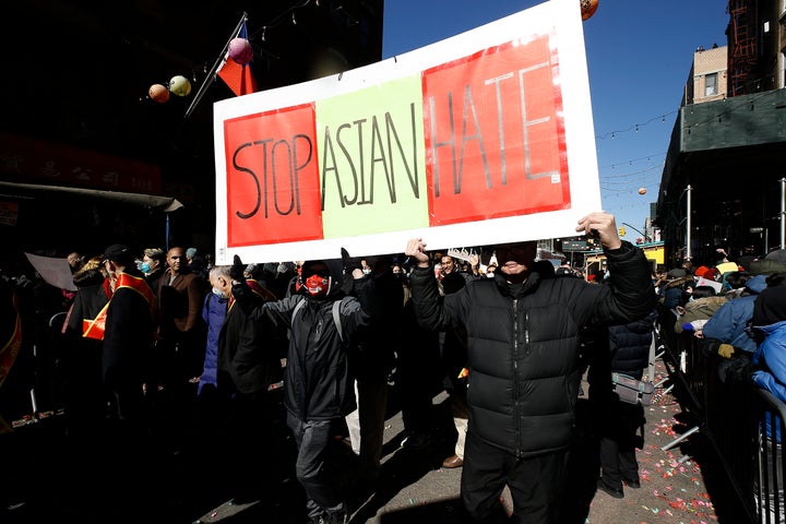 Participants hold a "Stop Asian Hate" sign as they march in the Chinatown Lunar New Year Parade in New York City on Feb. 20.