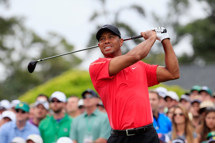 Tiger Woods watches his tee shot on the first hole during the final round of the 2015 Masters Tournament at Augusta National Golf Club on April 12, 2015 in Augusta, Georgia.