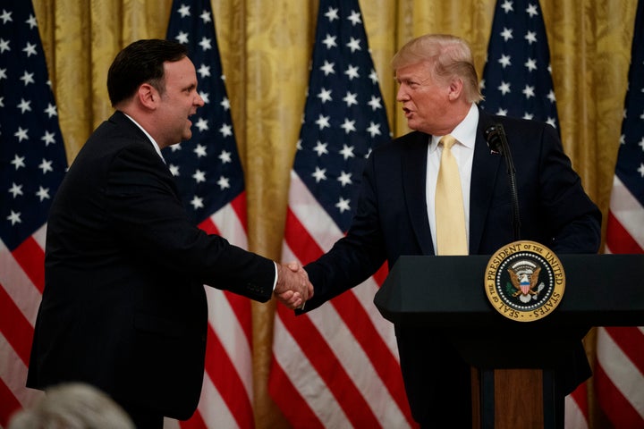 President Donald Trump shakes hands with White House social media director Dan Scavino during the Presidential Social Media Summit at the White House on July 11, 2019.