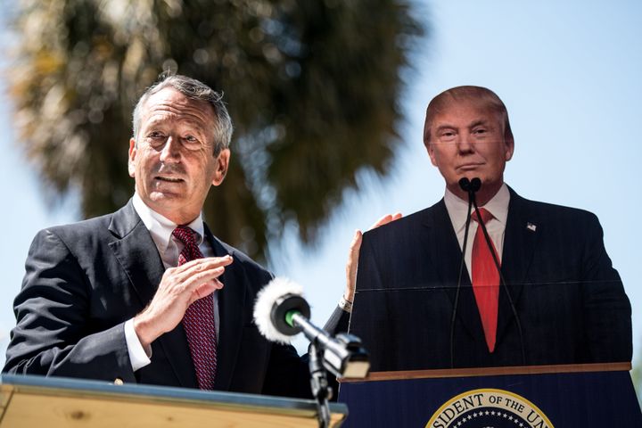 Former Rep. Mark Sanford (R) stands next to a cutout of then-President Donald Trump during a short-lived presidential run in 2019. Sanford embodied the Lowcountry's complex politics.