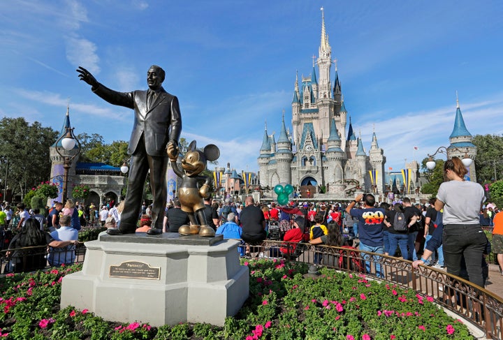 A statue of Walt Disney and Micky Mouse stand near the Cinderella Castle at the Magic Kingdom at Walt Disney World in Lake Buena Vista, Fla. on Jan. 9, 2019.