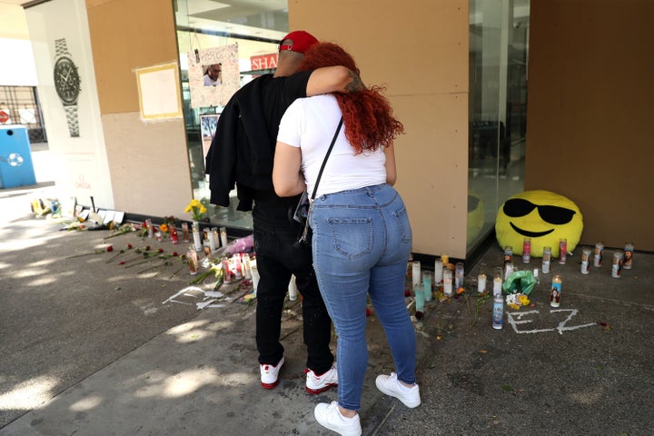 Xander Simpson and Britonnie Cooper, cousins of victim De'vazia Turner, console each other at the scene of Turner's death at 10th and K in Sacramento, Calif., on April 5, 2022. 