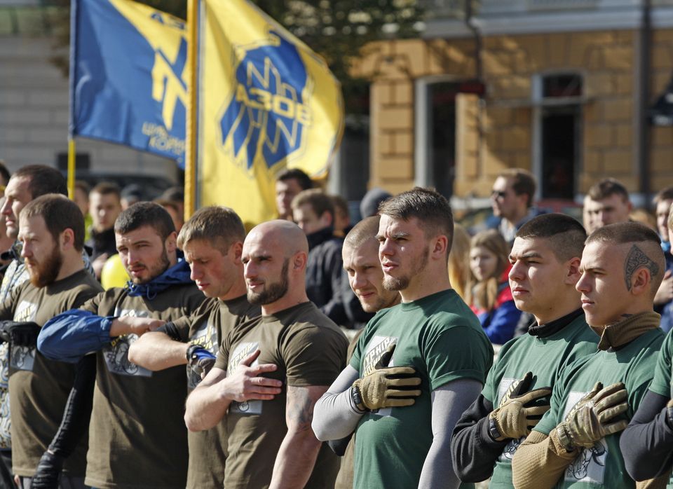 (Photo de combattants ukrainiens chantant l'hymne national de leur pays pendant une rencontre organisée...