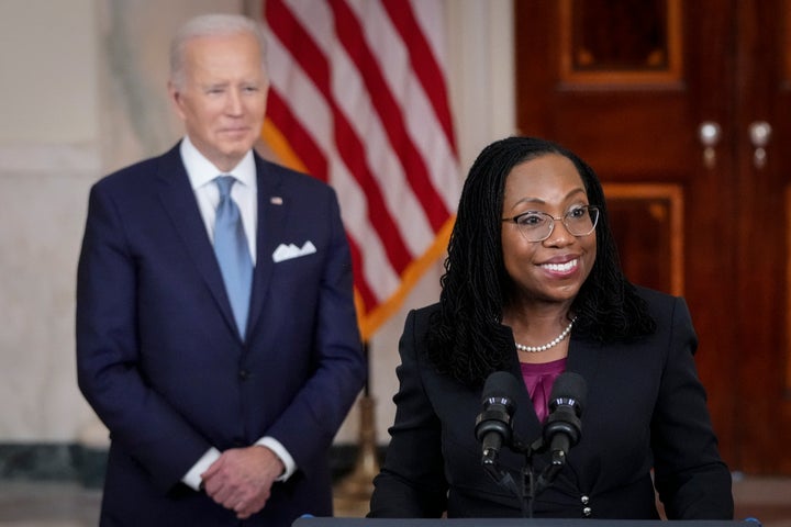 U.S. President Joe Biden (L) looks on as Ketanji Brown Jackson, circuit judge on the U.S. Court of Appeals for the District of Columbia Circuit, delivers brief remarks as his nominee to the U.S. Supreme Court during an event in the Cross Hall of the White House February 25, 2022 in Washington, DC. Pending confirmation, Judge Brown Jackson would succeed retiring Associate Justice Stephen Breyer and become the first-ever Black woman to serve on the high court. (Photo by Drew Angerer/Getty Images)