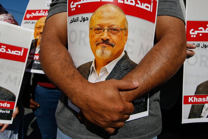 People hold posters of slain Saudi journalist Jamal Khashoggi, near the Saudi Arabia consulate in Istanbul on Oct. 2, 2020, marking the two-year anniversary of his death.