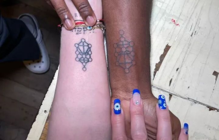 Madonna and son David with their new wrist tattoos. 