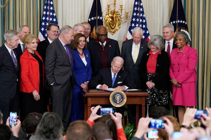 Pelosi is seen in blue attending a signing by President Joe Biden at the White House on Wednesday. Watching from left are Rep. Stephen Lynch, D-Mass., Sen. Tom Carper, D-Del., Rep. Carolyn Maloney, D-N.Y., Sen. Gary Peters, D-Mich., Senate Majority Leader Chuck Schumer of N.Y., Sen. Rob Portman, Rep. James Clyburn, D-S.C., Rep. Steny Hoyer, D-Md., Annette Taylor, Rep. James Comer, R-Ky., and Rep. Brenda Lawrence, D-Mich. 