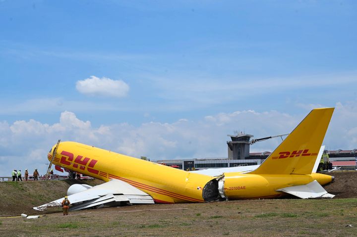 A DHL cargo jet slid off the runway and broke in half while landing at San Jose’s international airport Thursday, shutting down the airport, but not injuring crew.(AP Photo/Carlos Gonzalez)