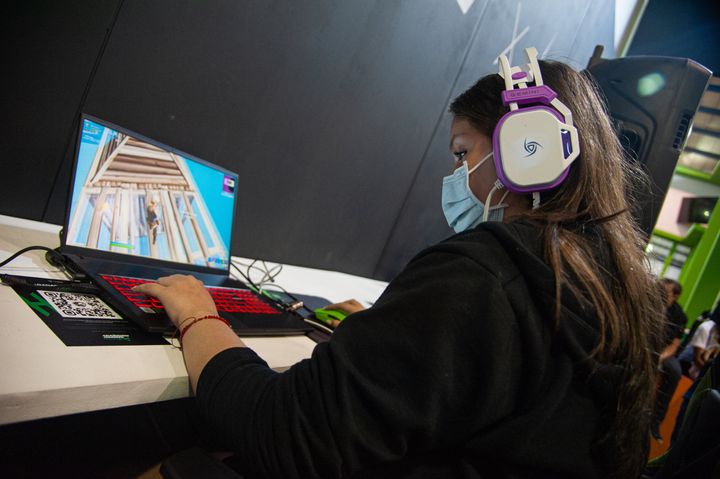 An attendee plays on her laptop during an Epic Games - Fortnite tournament on Oct. 17, 2021. 