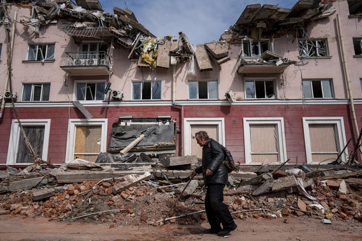 A man walks past a building damaged by shelling in Chernihiv, Ukraine, on Thursday.