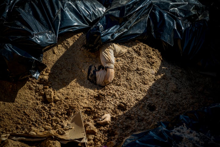 The bodies of Ukrainians killed by Russian troops in Bucha, Ukraine, fill a mass grave.