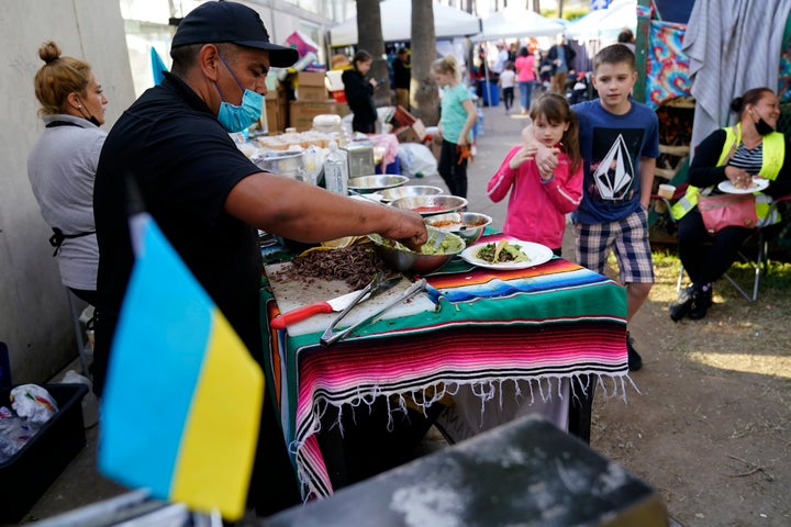 Mexican volunteer Felix Lara prepares tacos for Ukrainian refugees at a makeshift camp near the border, on April 4, 2022, in Tijuana, Mexico.