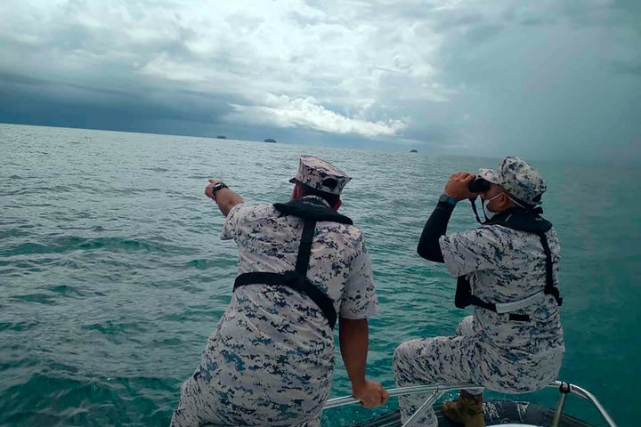 This photo released by the Malaysian Maritime Enforcement Agency (MMEA) on Friday, April 8, 2022, shows search and rescue operation for foreign divers off the coast of Johor's Mersing, Malaysia.