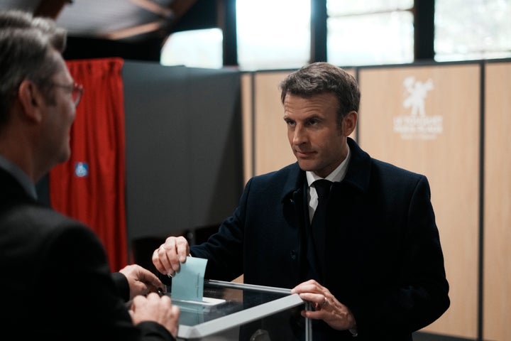 French President and centrist presidential candidate for reelection Emmanuel Macron casts his ballot for the first round of the presidential election, on April 10, 2022, in Le Touquet, northern France.