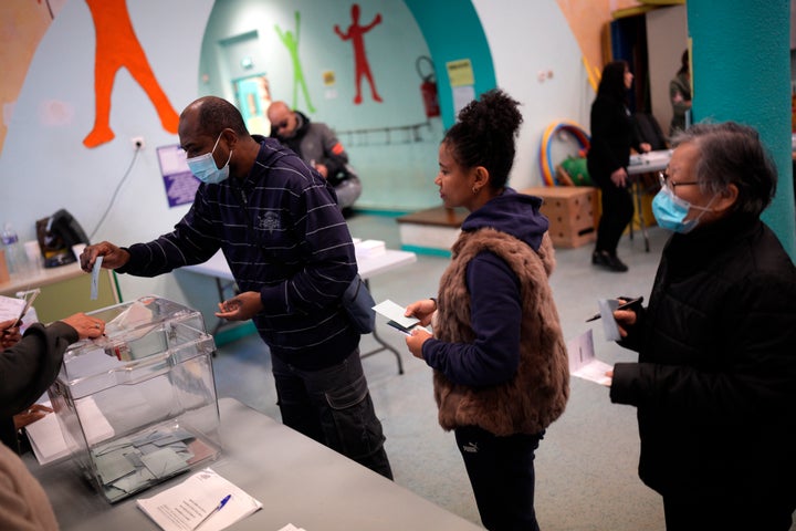 People queue to vote in the first round of the presidential election at a polling station on April 10, 2022, in Marseille, southern France.