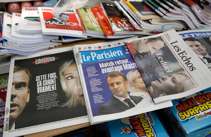 The front pages of the French newspapers, Le Figaro, Liberation are displayed in a newsstand with the photos of Emmanuel Macron and Marine Le Pen the day after the first round of the presidential elections.