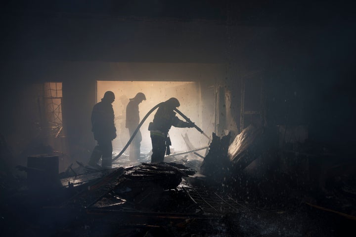 Firefighters work to extinguish a fire at a house after a Russian attack in Kharkiv, Ukraine, Monday, April 11, 2022. (AP Photo/Felipe Dana)