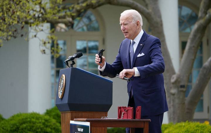 President Joe Biden holds a 9 mm pistol build kit as he speaks on measures to combat gun crime from the Rose Garden of the White House in Washington, D.C. on April 11.