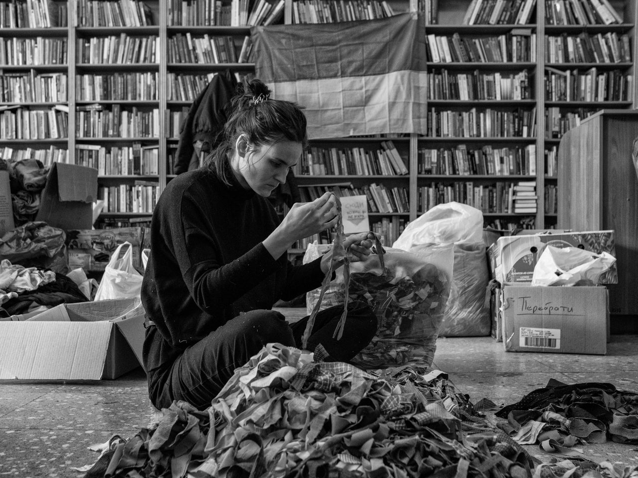 A volunteer sorts through various materials that will be used to make camouflage netting for the military in Ukraine.