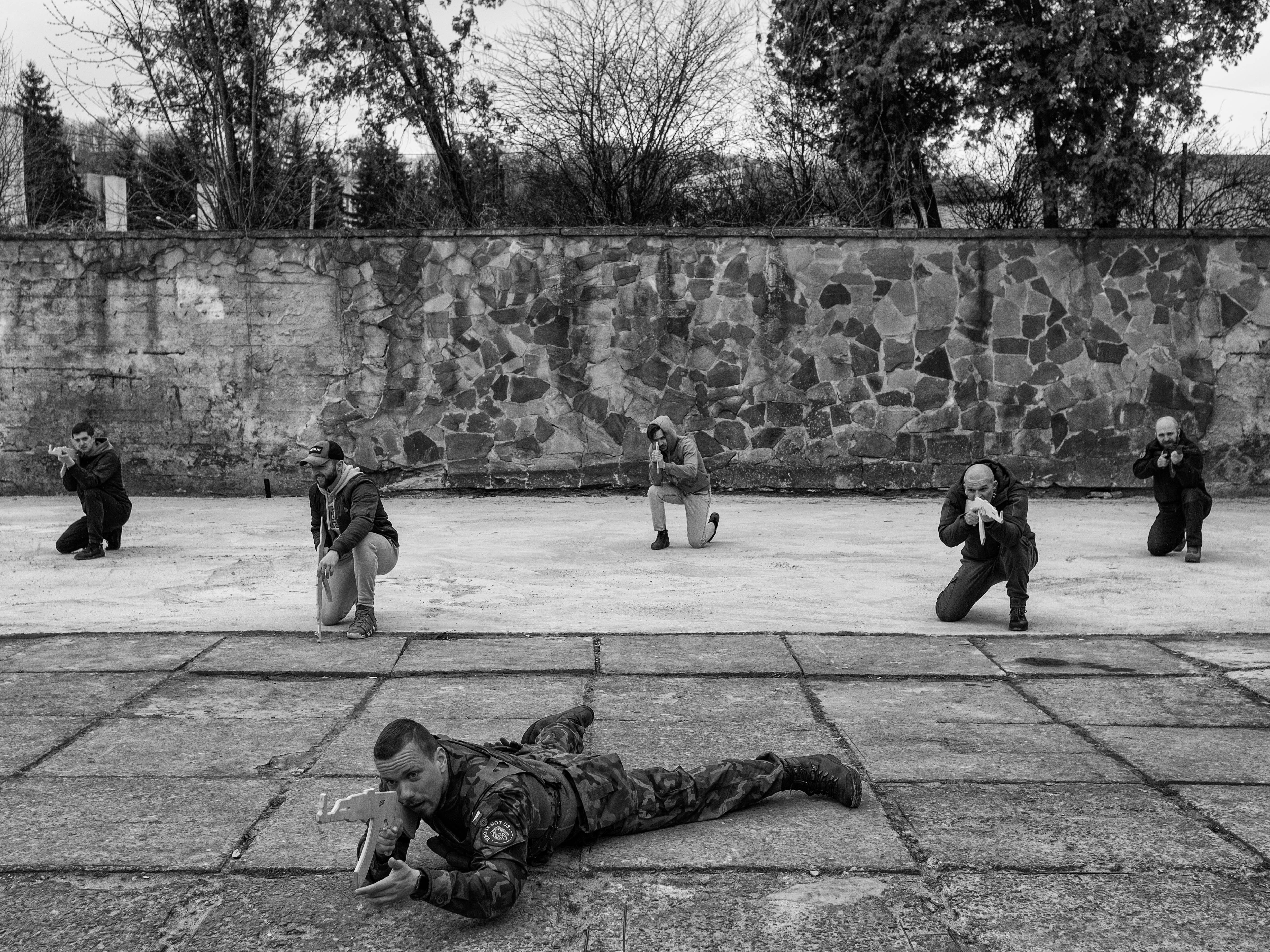 Young men in the civilian world partake in firearms training in Lviv.