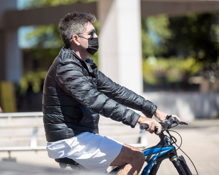 Simon is seen riding an e-bike in West London.