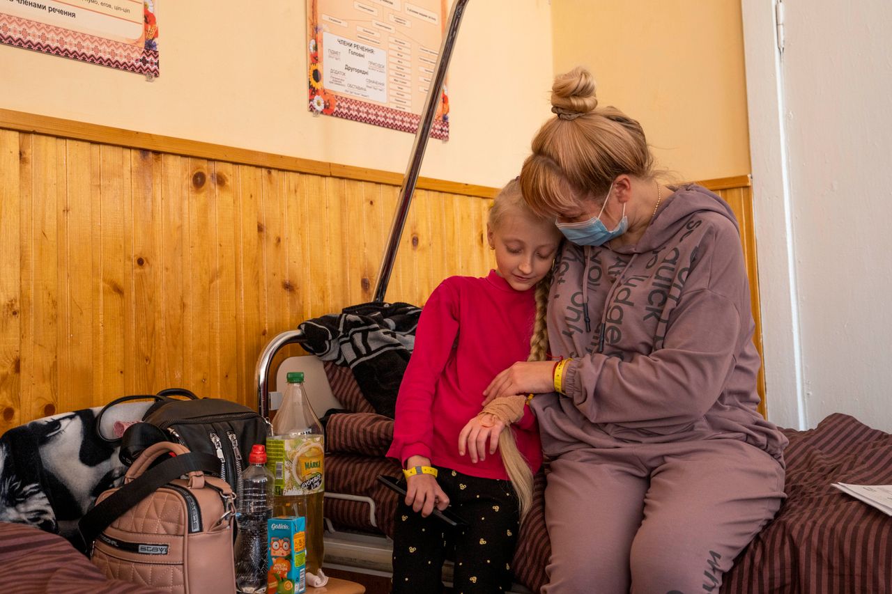 Natalia Moiseinko holds her 10-year-old daughter Zlata, who is suffering from a chronic heart condition, as she receives treatment at a schoolhouse that has been converted into a field hospital in Mostyska, Ukraine. 