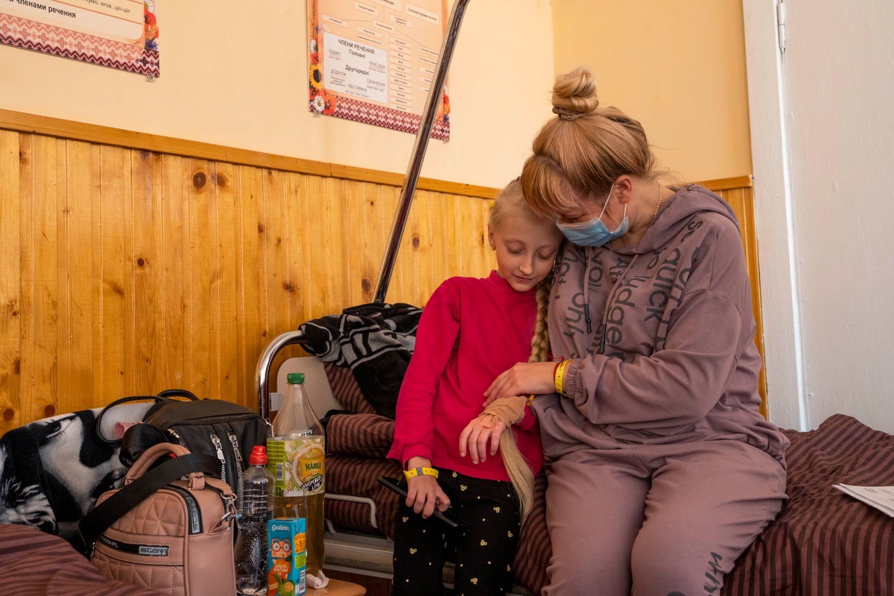 Natalia Moiseinko holds her 10-year-old daughter Zlata, who is suffering from a chronic heart condition, as she receives treatment at a schoolhouse that has been converted into a field hospital in Mostyska, Ukraine.