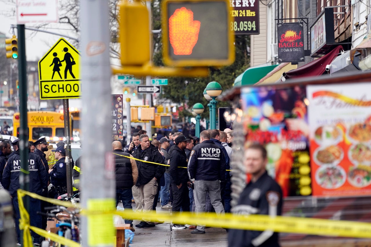 New York City Police Department personnel gather at the entrance. 