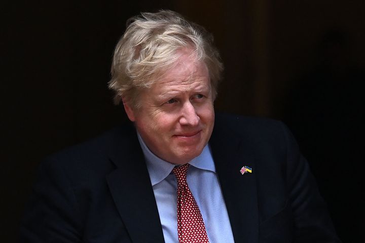 Britain's Prime Minister Boris Johnson walks out of number 10 Downing Street to greet the Polish president in London on April 7, 2022. (Photo by JUSTIN TALLIS / AFP) (Photo by JUSTIN TALLIS/AFP via Getty Images)