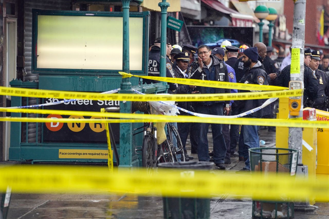 New York City Police Department personnel gather at the entrance to a subway stop in Brooklyn on Tuesday.