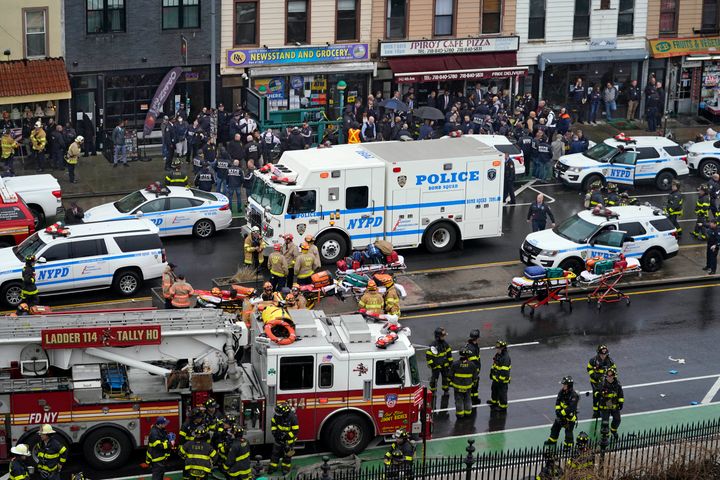 Emergency personnel gather at the entrance to a subway stop in Brooklyn.