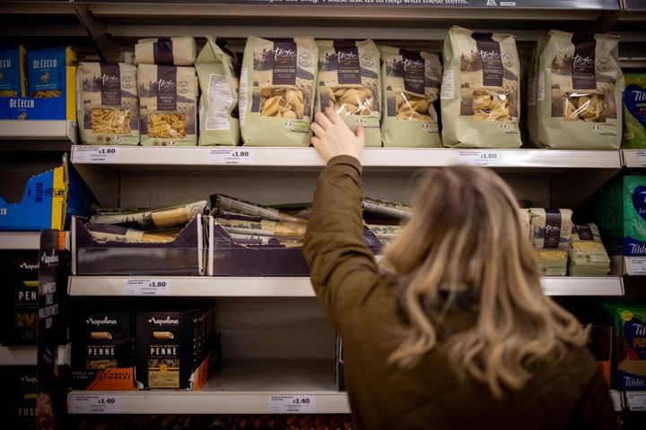 A customer shops for pasta at a supermarket