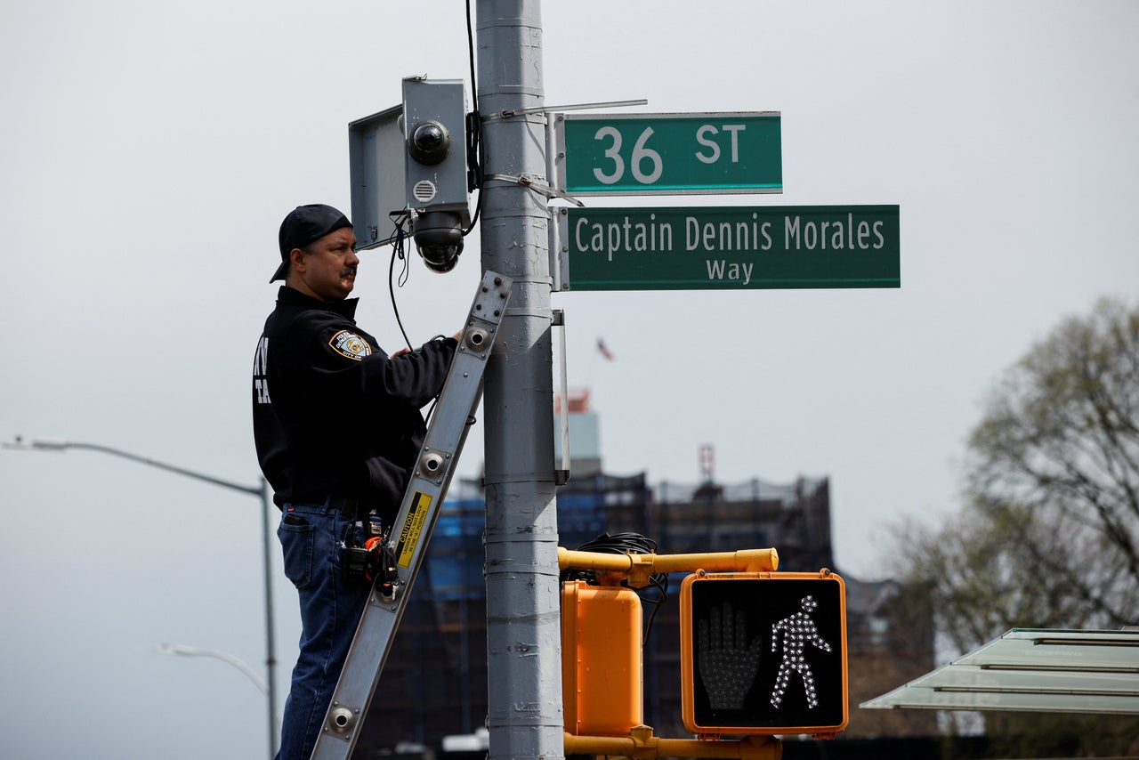 Emergency personnel check the cameras near the shooting scene. 